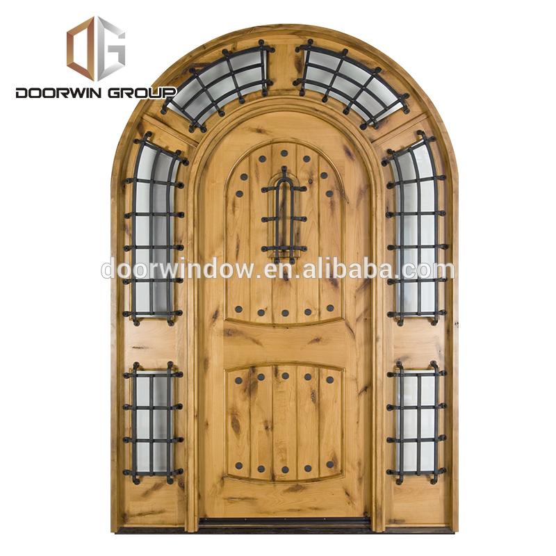 DOORWIN 2021Church gate style design exterior wood front doors with top carving glass entry door with side lite rustic door by Doorwin