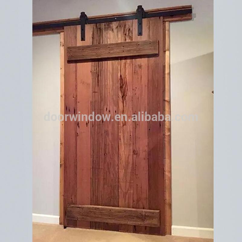 DOORWIN 2021Old knotty alder pine larch wooden door slats designs by-passing sliding barn door with heavy track by Doorwin