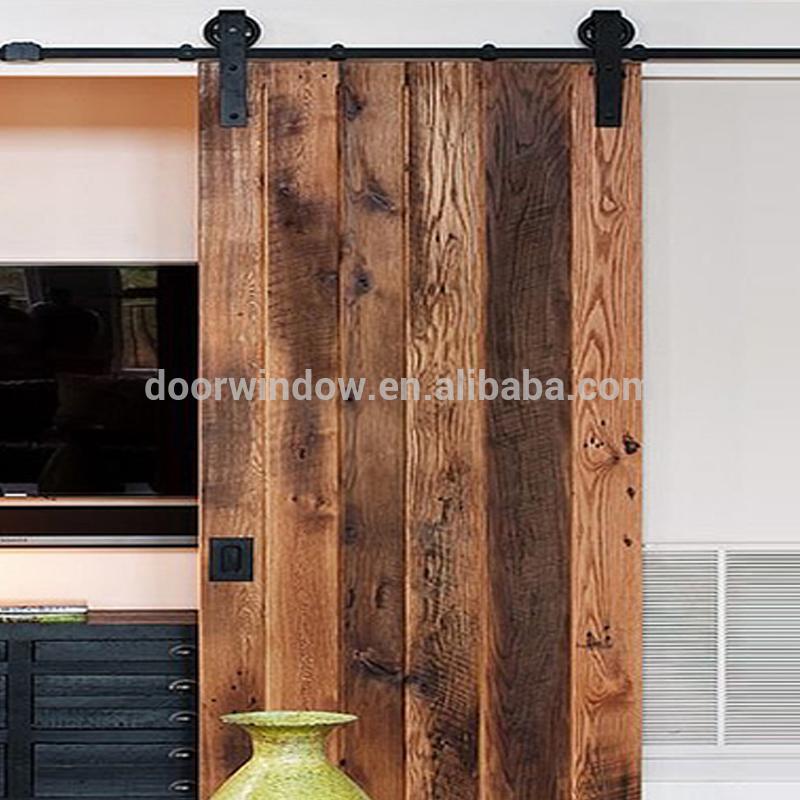 DOORWIN 2021Old knotty alder pine larch wooden door slats designs by-passing sliding barn door with heavy track by Doorwin